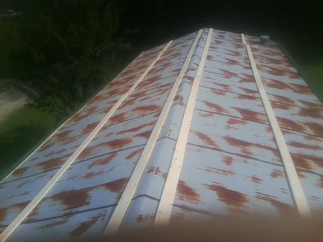 Rusted metal roof panels with new wood purlins before replacement — Storm Damage Roof Repair in Sparrows Point by Roofing Brothers